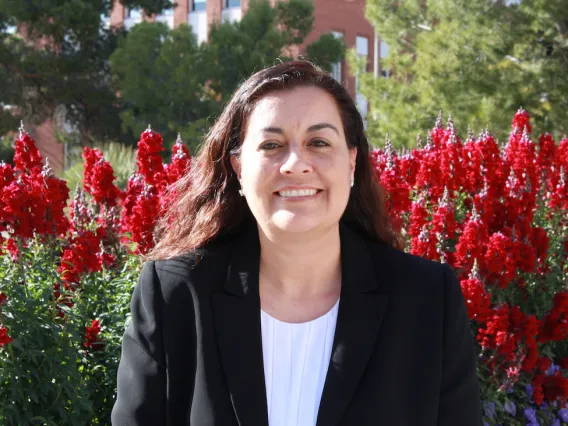 photo of Christine Salvesen in front of flowers 