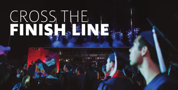 Students looking at the screen during graduation. "Cross the Finish Line"